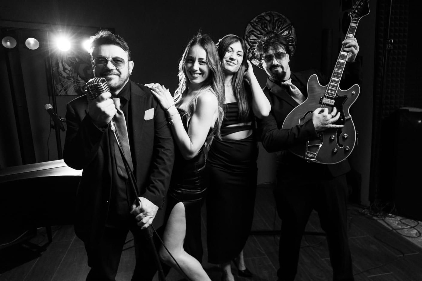 Gruppo musicale in posa in bianco e nero, cantanti e chitarrista